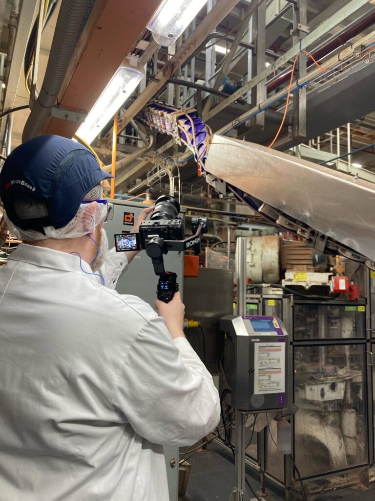Videographer filming Cadbury chocolate production in factory
