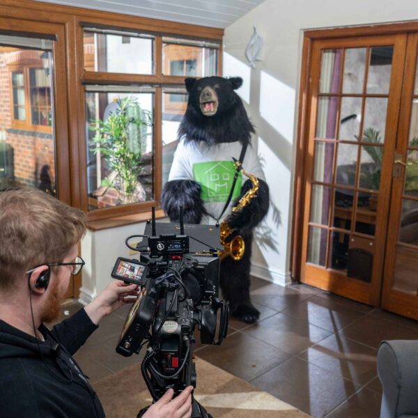Spark Media videographer filming Conservandsave bear playing saxophone