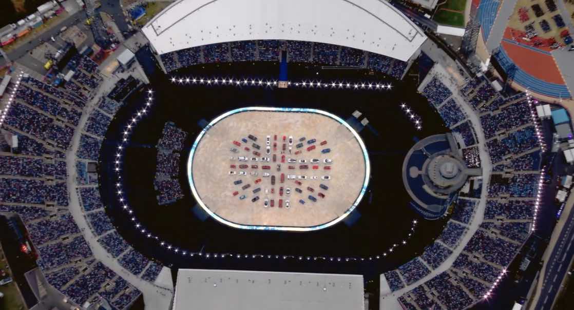 Birds eye view of sports stadium at London 2012 olympics with UK flag made out of people