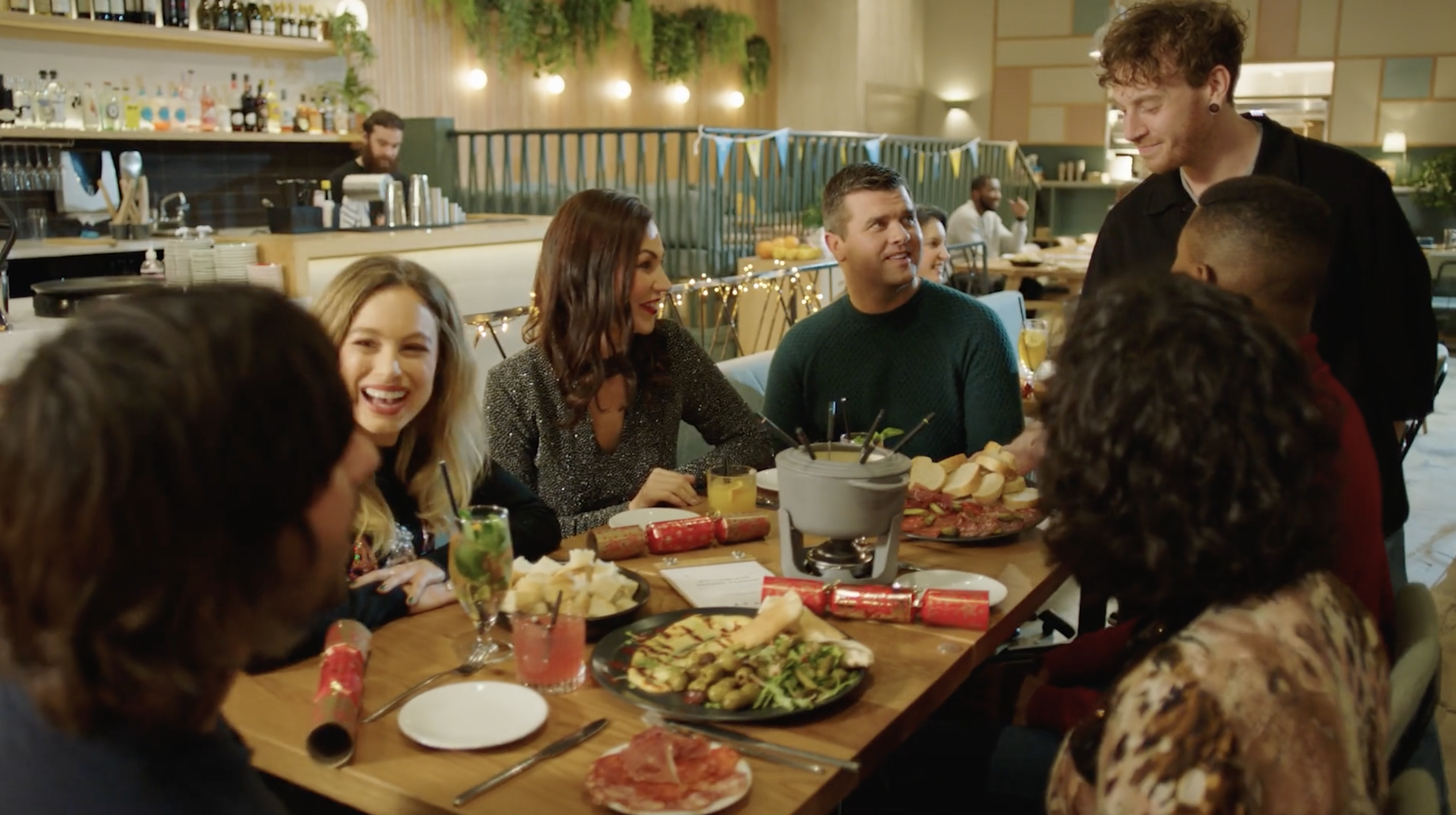 Friends sitting at table for Christmas roast dinner