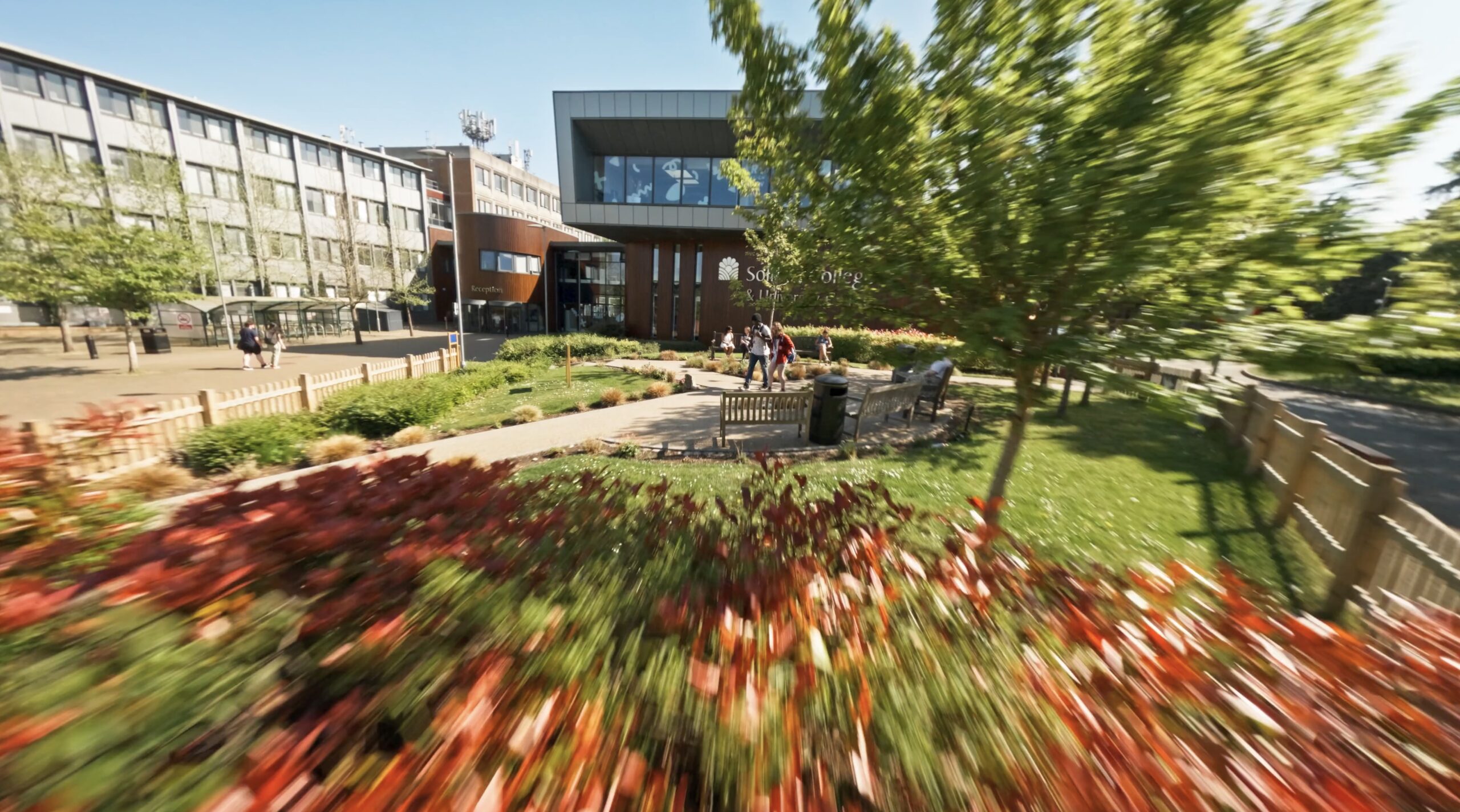 Solihull college building with blue sky and trees