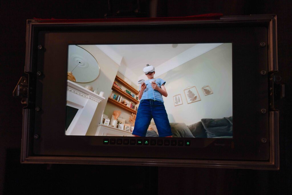 Monitor showing shot of boy with VR headset from low angle in shot for Luceco TV ad
