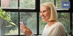 Woman with blonde hair looking at phone in kitchen in Luceco TV ad