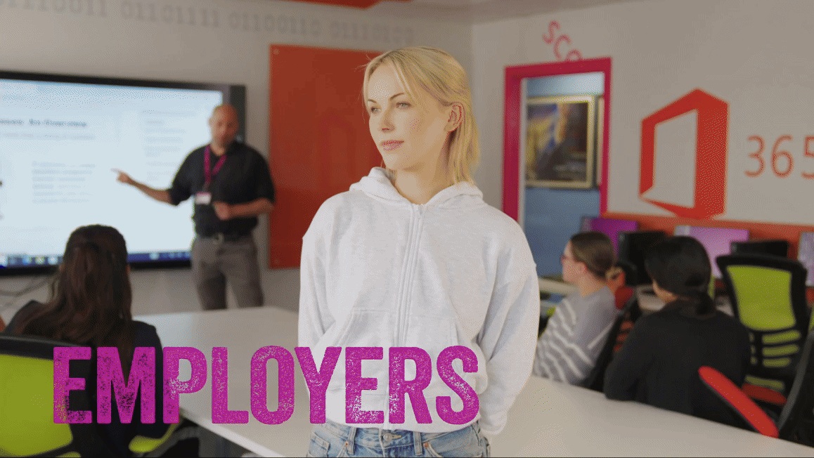 A blonde woman stood up staring directly at camera. South and City College Birmingham logo moves over the screen revealing the same student in a different environment - a computer lab. Her dream career.