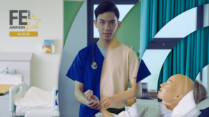 A male medical student checking the pulse of a manikin in a hospital bed. He is stood up staring directly at camera. South and City College Birmingham logo moves over the screen revealing the same student in a different environment - a hospital, checking the pulse of a real patient. He is now wearing medical scrubs. This is his dream career.