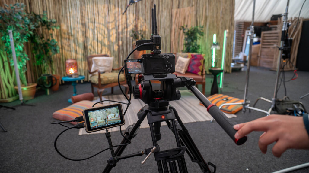 Camera on tripod filming the West Midlands Safari Lodge set