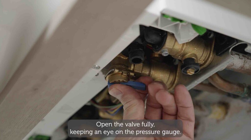 Hand opening valve. Text reads open the valve fully keeping an eye on the pressure gauge.